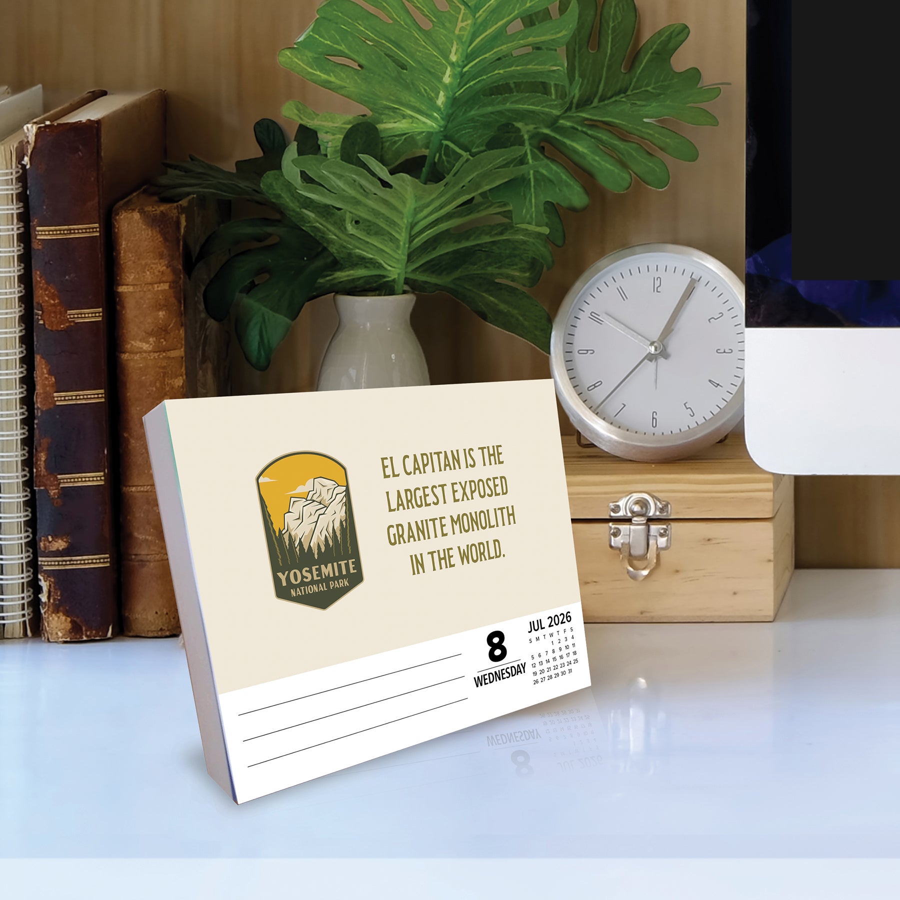 National Park Trivia 2026 Daily Box Calendar featuring El Capitan fact and design on a desk with plants and books.