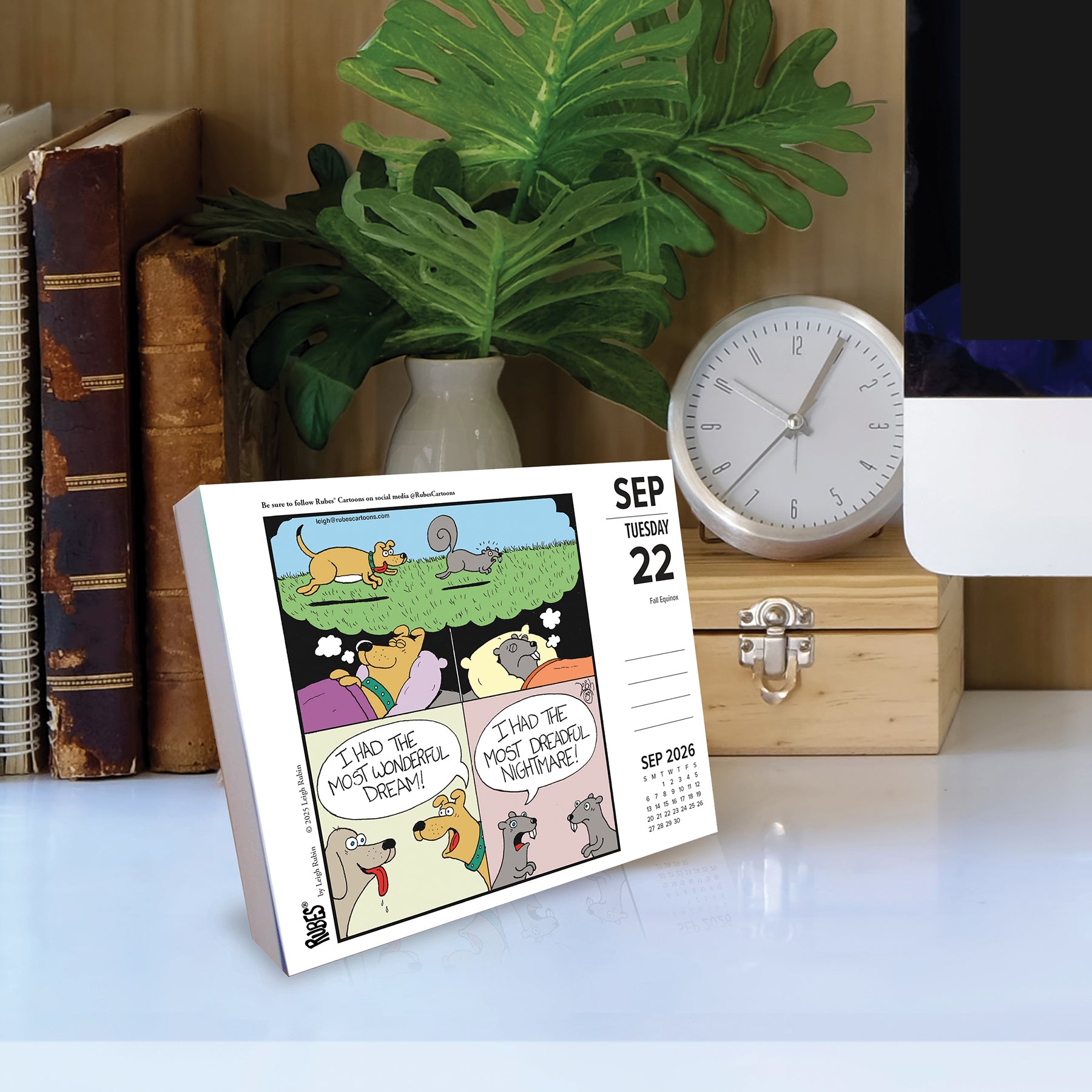 2026 Daily Box Calendar featuring humorous animal cartoons by Leigh Rubin on a desk with a clock and books.