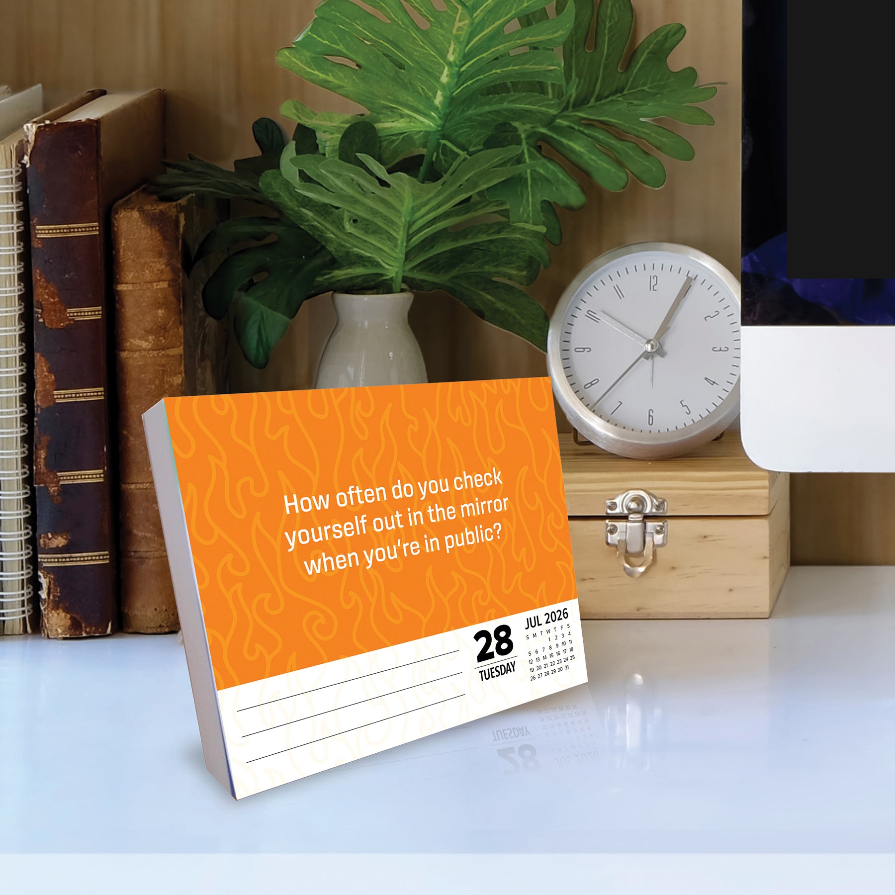 2026 Daily Box Calendar featuring a bold question prompt for conversation on a desk with books and a clock.